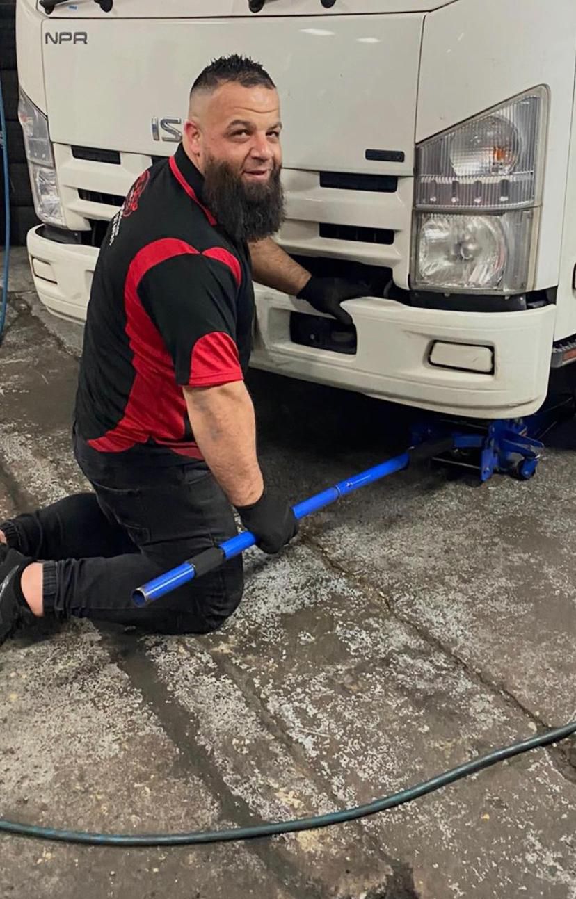 Team member working on truck tyre